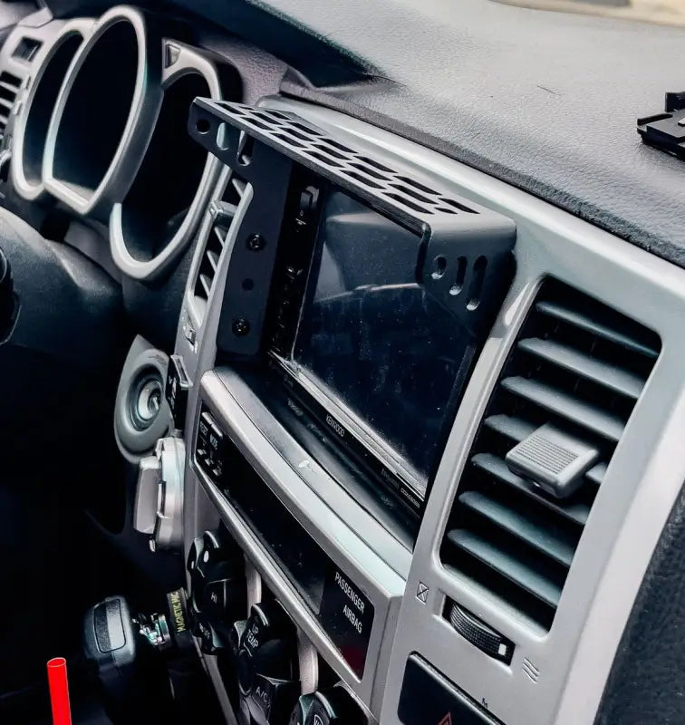 4th Gen 4Runner modular dash accessory mount installed on center console, showcasing compatibility with phones and GPS devices.