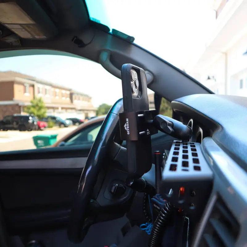 4th Gen 4Runner modular dash mount installed in vehicle, holding a phone and walkie-talkie for convenient access while driving.