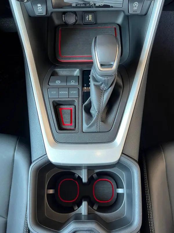 Close-up of center console foam inserts with red trim in a 2019-2024 Toyota Rav4, providing a stylish and functional interior upgrade.