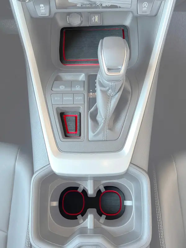 Center console foam inserts with red accents installed in a 2019-2024 Toyota Rav4, enhancing interior decor and protecting surfaces.