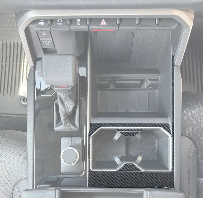 Center cup holder accent trim installed in a 2022-2024 Toyota Tundra or 2023-2024 Toyota Sequoia interior, showcasing a sleek carbon fiber design.