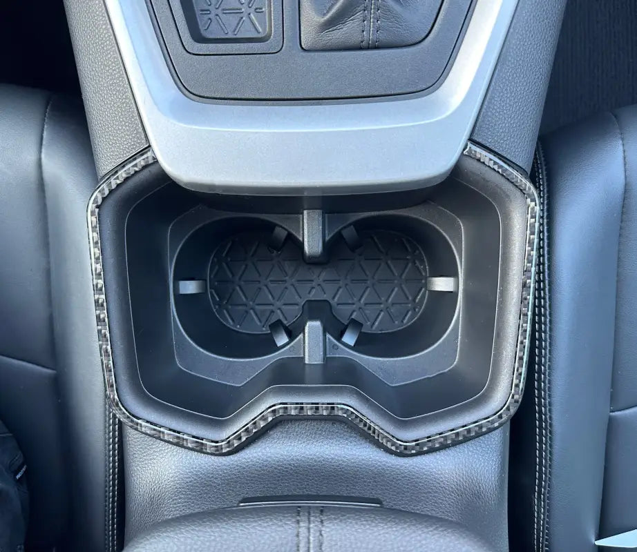 Close-up of center cupholder accent trim fitted in a Toyota Rav4, highlighting precise fit and stylish detailing.