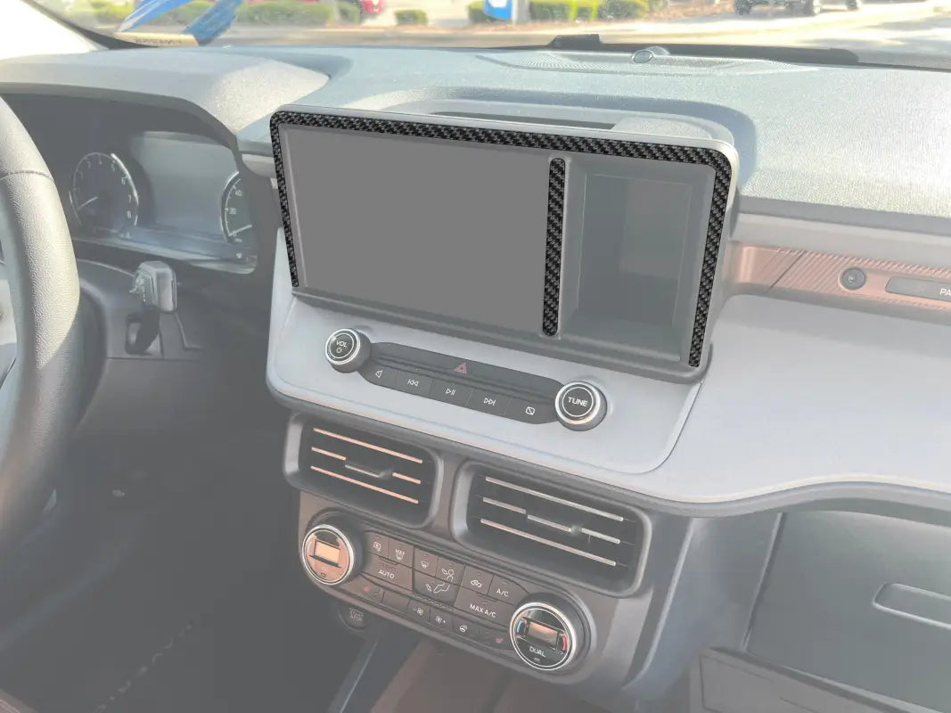 Car dashboard with carbon fiber trim featuring center display screen accent overlays for Ford Maverick
