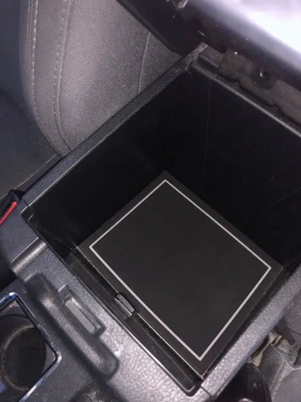 Close-up of center storage compartment foam insert fitted in a 2016-2023 Toyota Tacoma, enhancing interior organization.