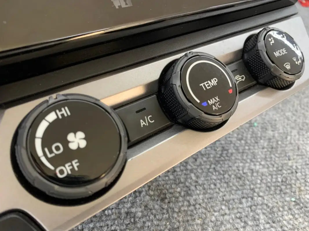 Black climate control rings installed on 2016-2023 Toyota Tacoma dashboard, providing a bold look.
