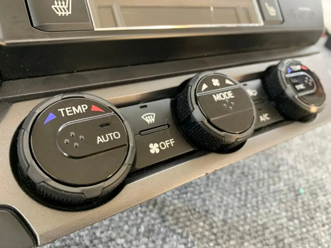 White climate control rings installed on 2016-2023 Toyota Tacoma dashboard, creating a clean aesthetic.