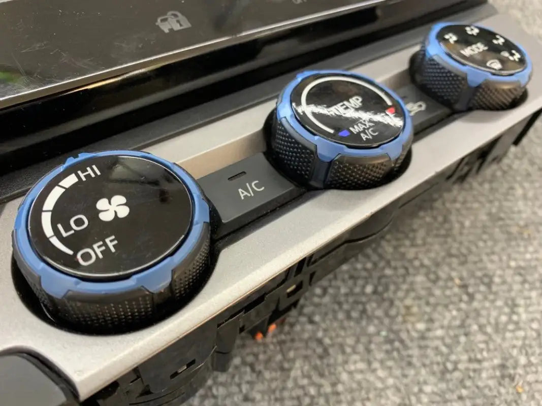 Blue climate control rings installed on 2016-2023 Toyota Tacoma dashboard, adding a custom look.