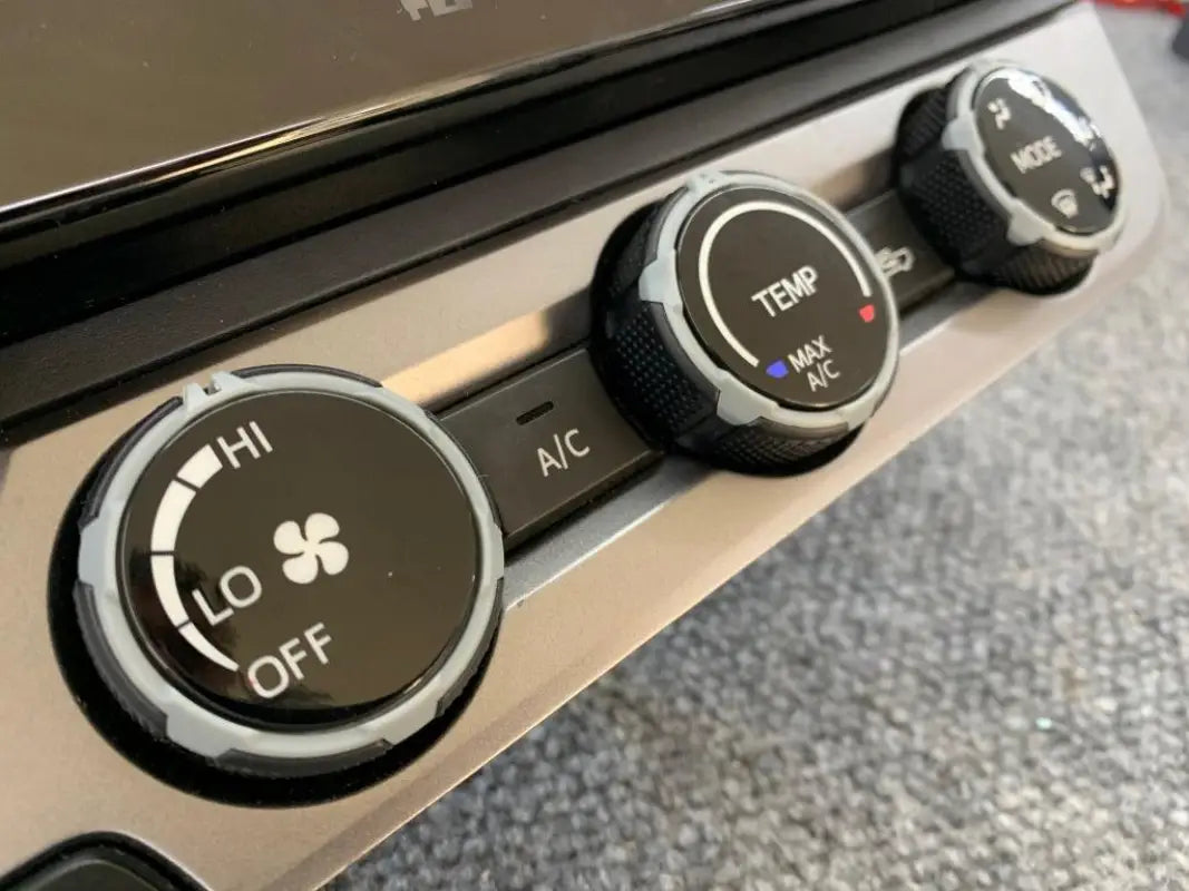 Gray climate control rings installed on 2016-2023 Toyota Tacoma dashboard, offering a sleek appearance.