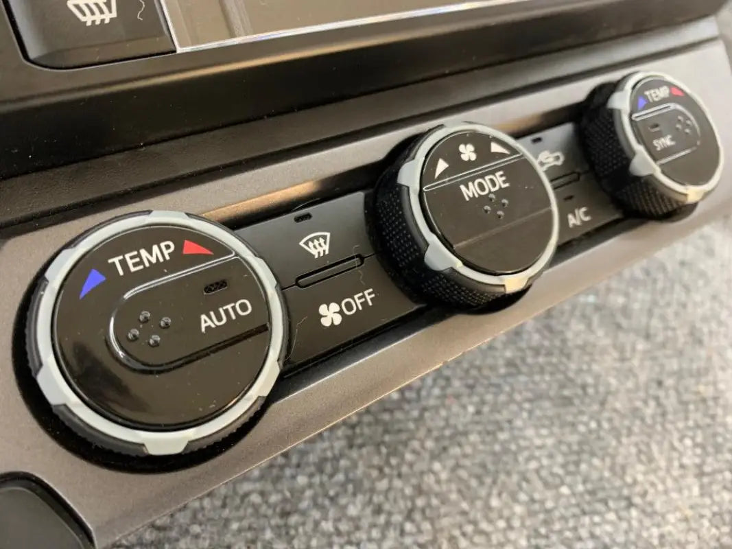 Black climate control rings installed on digital climate controls of 2016-2023 Toyota Tacoma.