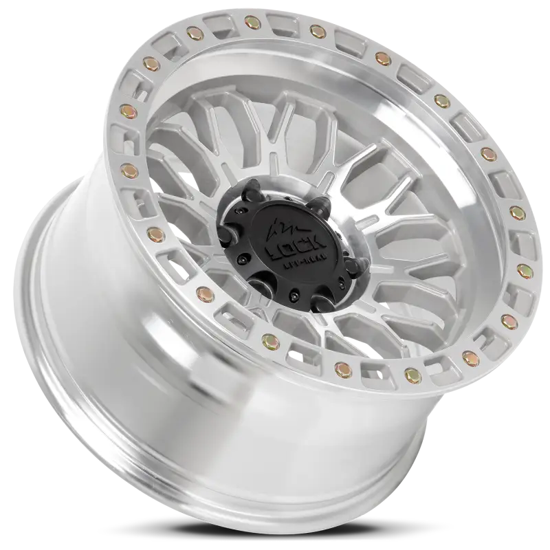 Angled view of Combat Machine Face Polish wheel showcasing its intricate mesh-block design, vented chambering, and robust off-road construction.