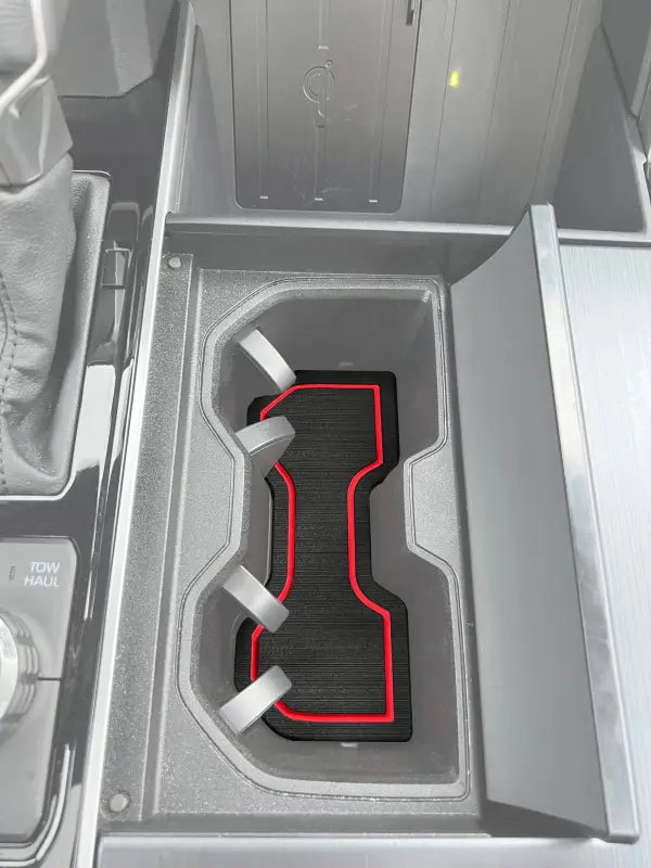 Cup holder foam insert with red trim installed in the center console of a 2022-2024 Toyota Tundra or 2023-2024 Toyota Sequoia.