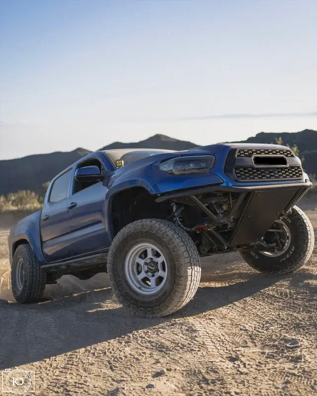 Blue Toyota Tacoma off-road truck with Custom Pre Runner Bumper and upgraded lower radiator support