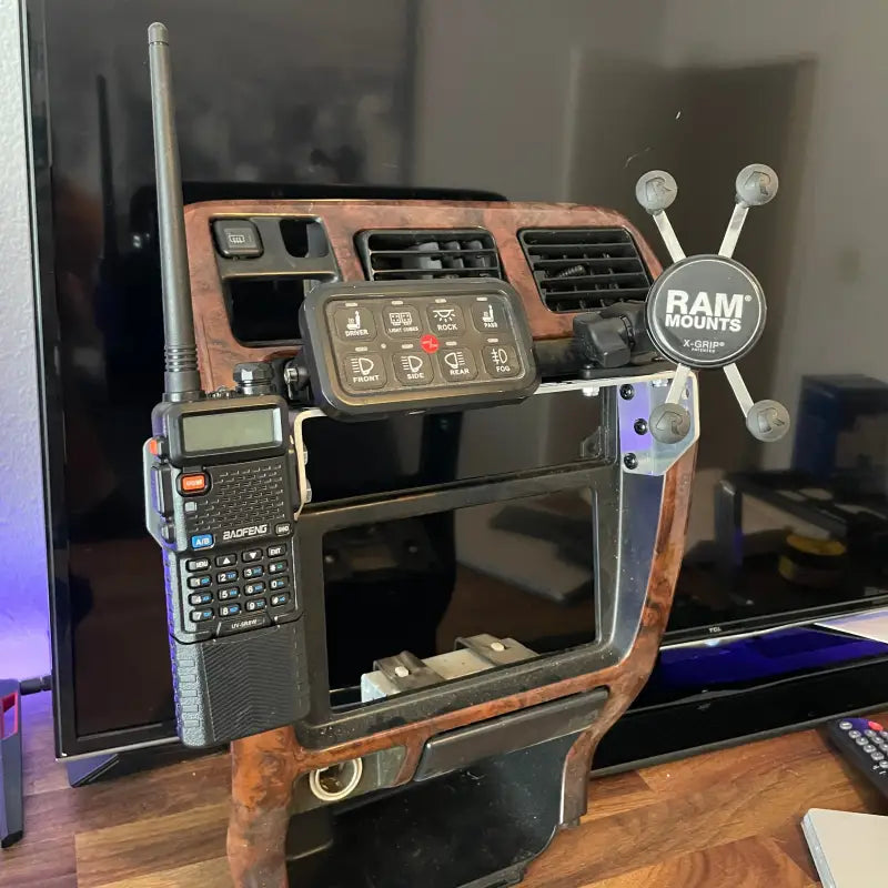 Tacoma modular console mount with multiple accessories, including a RAM mount and walkie-talkie, for 98-04 Toyota dashboards.