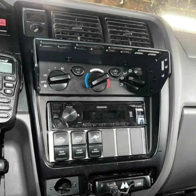 Tacoma modular console mount installed with multiple accessories, including a radio and switches, for 98-04 models.