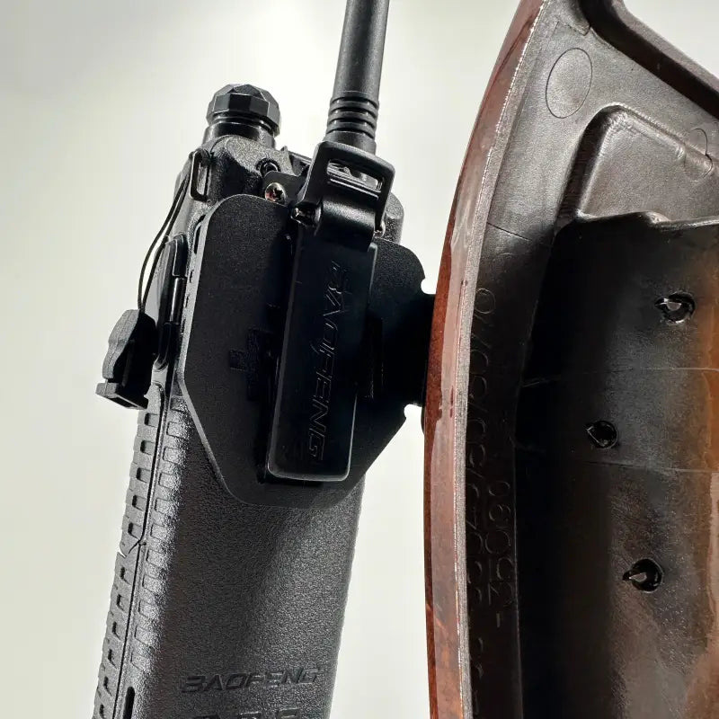 Close-up of walkie-talkie mounted on Tacoma modular console mount, showcasing secure attachment for 98-04 models.