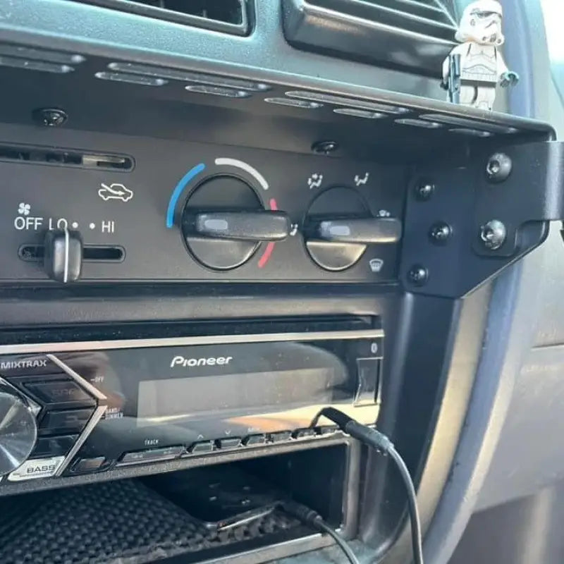 Close-up of Tacoma modular console mount with accessory slots and mounted phone holder, designed for 98-04 dashboards.