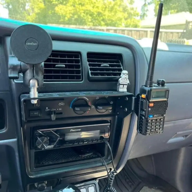 Tacoma modular console mount with walkie-talkie and magnetic phone holder, designed for 98-04 Toyota dashboards.