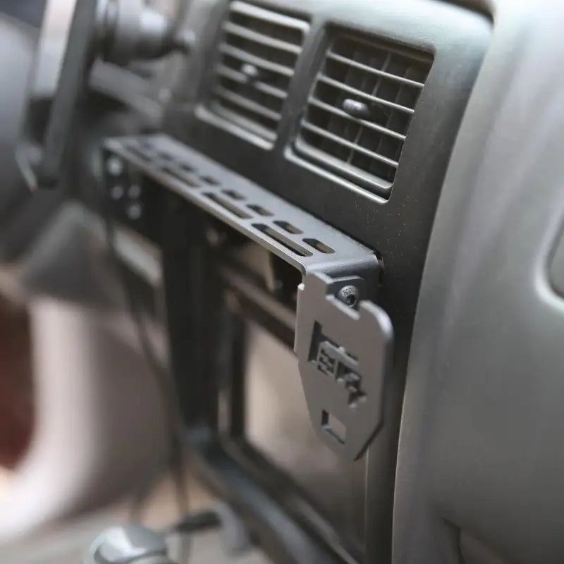 Tacoma modular console mount installed on dash, showcasing laser-cut design and multiple accessory slots for 98-04 models.
