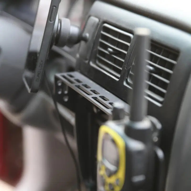 Tacoma modular console mount with walkie-talkie and GPS device attached, ideal for off-road use in 98-04 models.