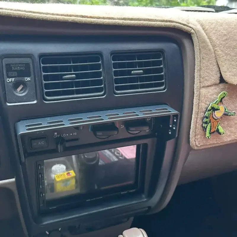 Tacoma modular console mount installed on dash with a clean design, showcasing accessory slots for 98-04 Toyota models.