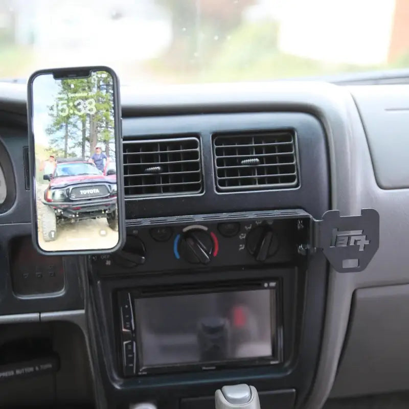 Tacoma modular console mount in use with a smartphone holder, installed on a 98-04 dashboard for added functionality.
