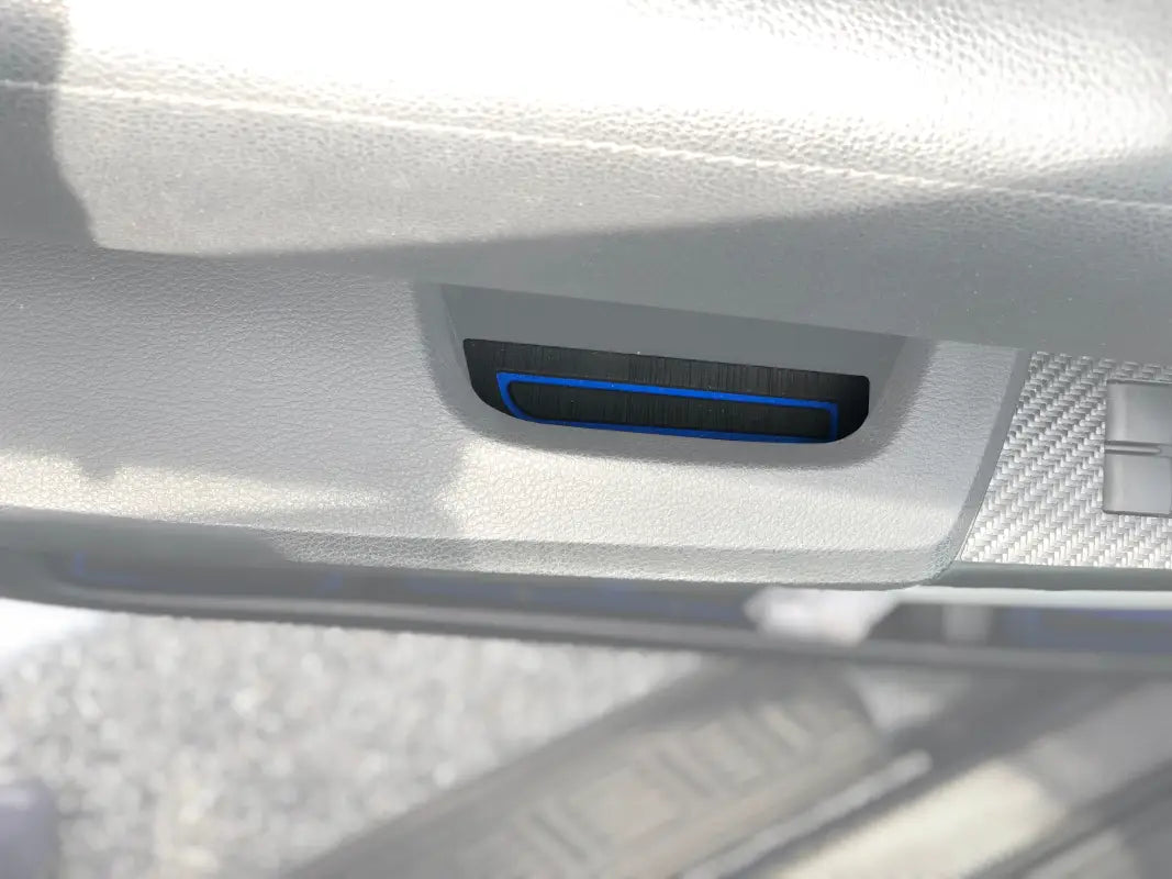 Close-up view of a door armrest insert with a black and blue design installed on a 2014-2021 Toyota Tundra interior.