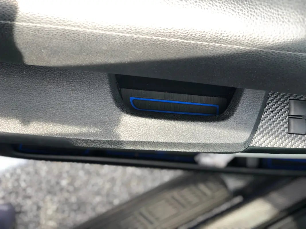 Detailed view of a black and blue door armrest insert fitted on the interior of a 2014-2021 Toyota Tundra.