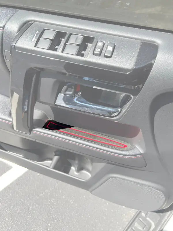 Door handle foam insert with red accent installed on a 2010-2024 Toyota 4 Runner interior, enhancing style and protection.