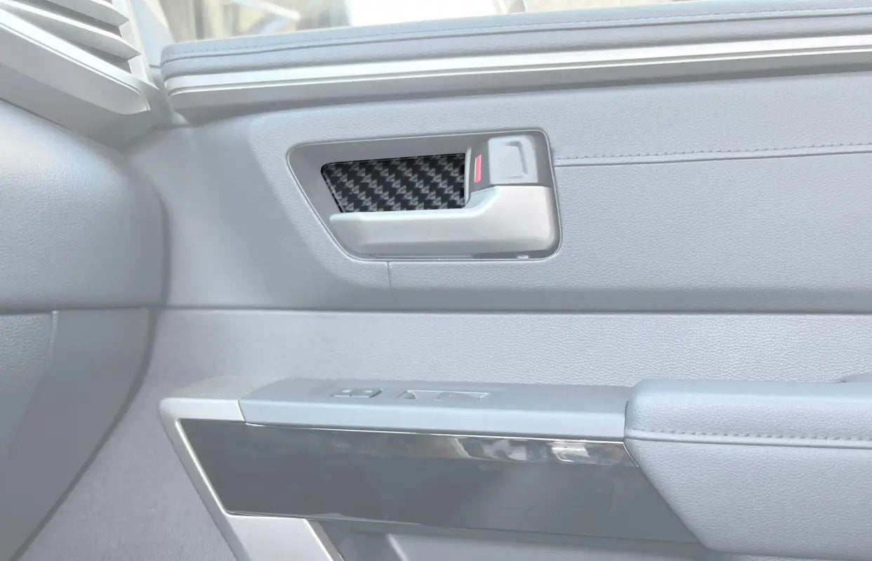 Carbon fiber door handle pocket accent trim installed on the interior of a 2022-2024 Toyota Tundra or 2023-2024 Toyota Sequoia.