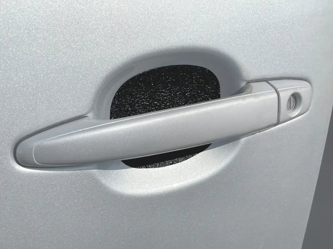 Black textured door handle protective insert installed on a silver Toyota Tacoma, compatible with 2005-2015 and 2024-up models.