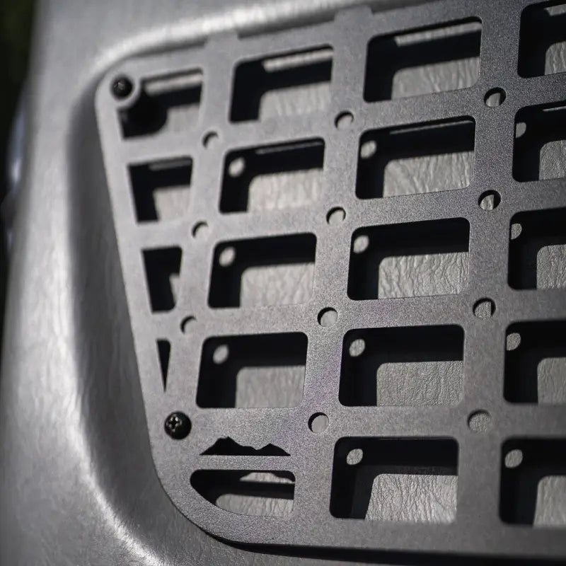Detailed view of the 2nd Gen Tacoma molle panel's laser-cut aluminum grid and powder-coated finish, designed for 2012-2015 models.