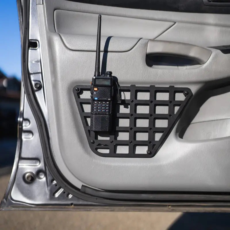 2nd Gen Tacoma molle panel with a mounted radio, emphasizing its durable and rustproof aluminum design for 2012-2015 models.
