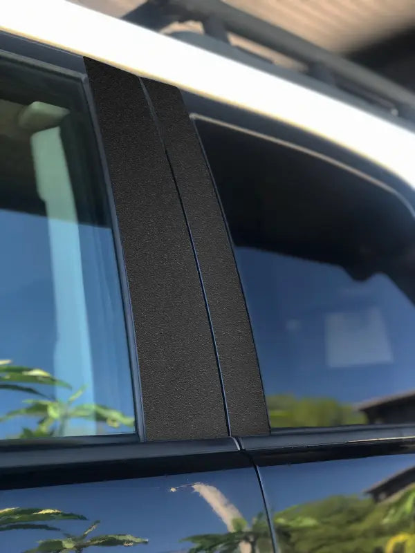 Matte black door pillar accent trim installed on a Toyota FJ Cruiser, offering a clean and modern vehicle enhancement.