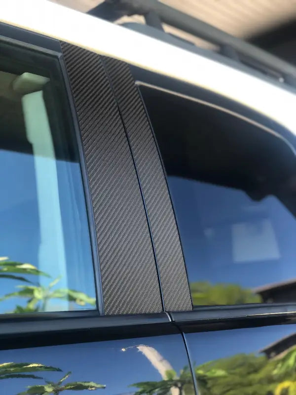 Close-up view of textured black door pillar accent trim on a Toyota FJ Cruiser, highlighting its stylish and precise fit.