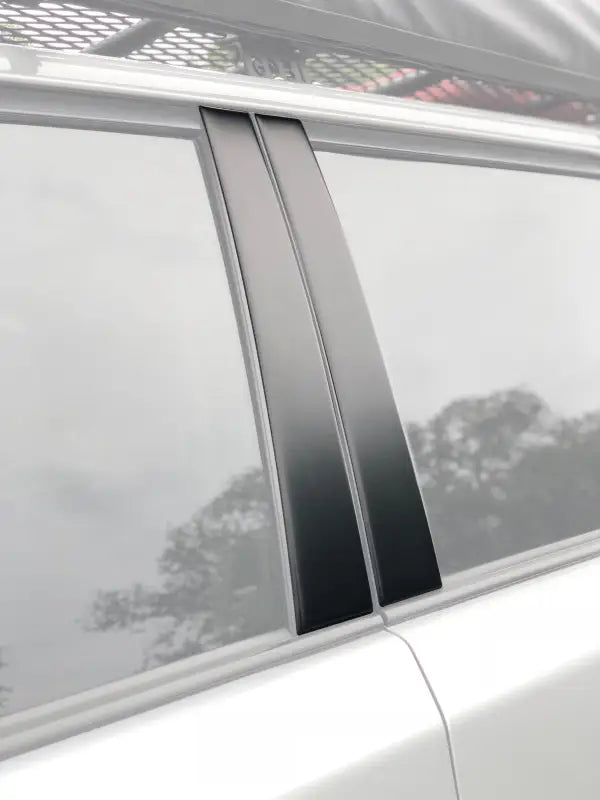 Gloss black door pillar accent trim installed on a Toyota 4Runner, enhancing the vehicle's exterior style.