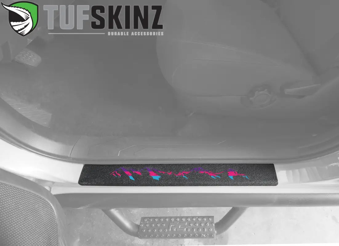 Textured black door sill overlay with pink and blue mountain design for 2005-2023 Toyota Tacoma, offering a vibrant interior upgrade.