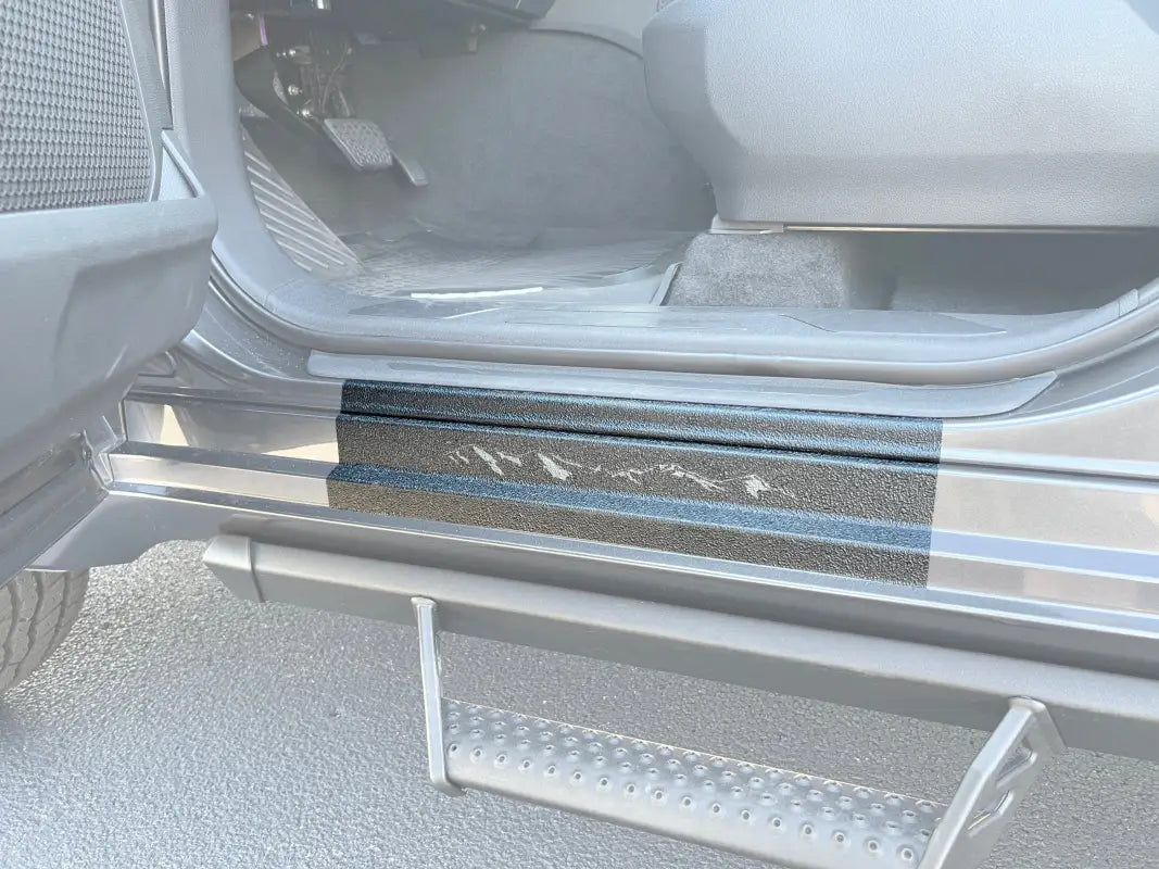 Black door sill protection overlay installed on a 2022-2024 Toyota Sequoia, showcasing a textured finish and precise fit.
