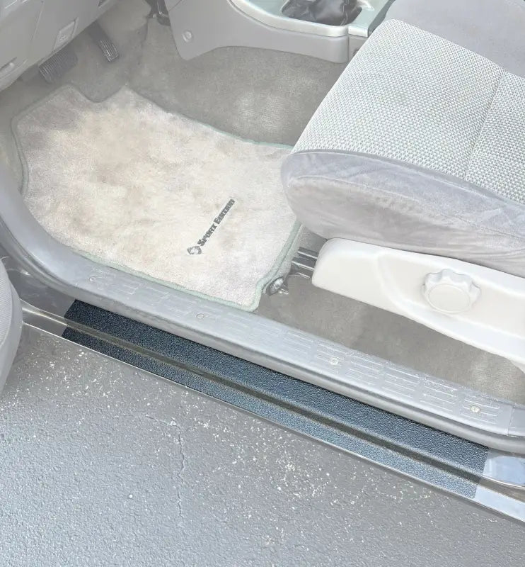Installed door sill protection overlays on a 1995-2002 Toyota 4Runner interior, showcasing durable black material for added protection.