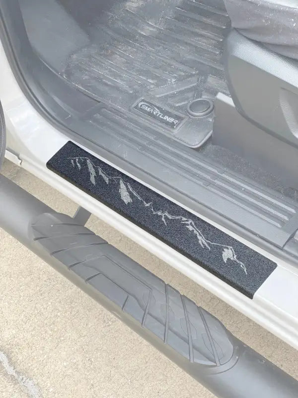 Textured black door sill protection overlay with mountain design for Ford Ranger 2019-2023