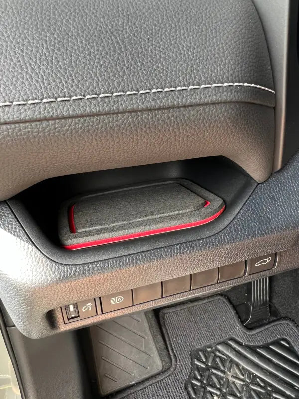 Close-up of driver side dash cubby foam insert with red accent, designed for 2019-2024 Toyota Rav4, showcasing precise fit and stylish design.
