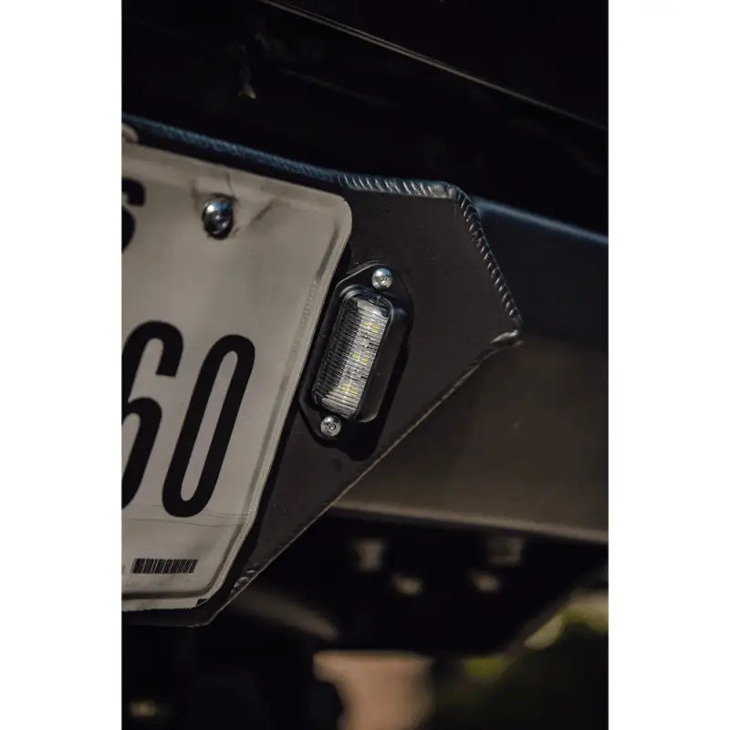 Close-up of license plate light integration on the DRT high clearance rear bumper for 2005-2015 Toyota Tacoma, showcasing precision design.