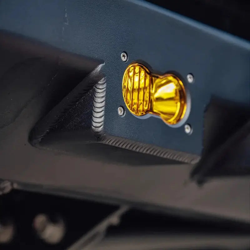 Detailed view of yellow recovery point on DRT high clearance rear bumper, emphasizing durable welds and design.