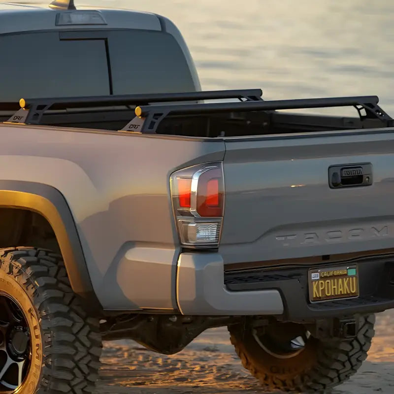 DRT Tacoma Lo-Pro Bedbars installed on a 2005-2023 Toyota Tacoma, showcasing durable steel construction and low-profile design.