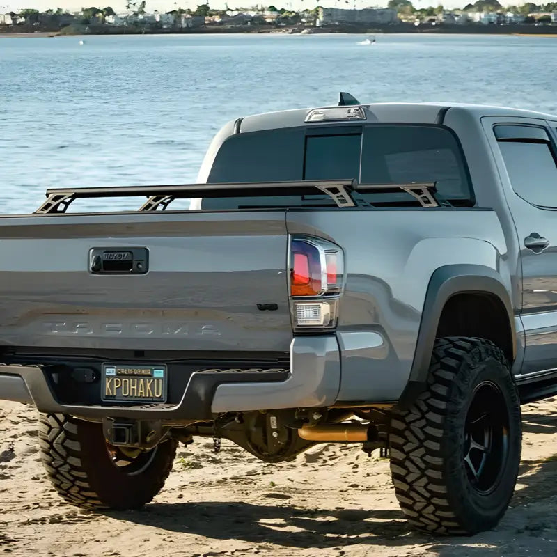 Rear view of DRT Tacoma Lo-Pro Bedbars on a Toyota Tacoma, highlighting lightweight steel build and compatibility with 2005-2023 models.