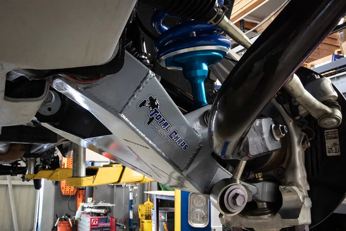 Close-up of Total Chaos Tundra Lower Control Arm installed on a vehicle, highlighting robust construction and precise fitment.