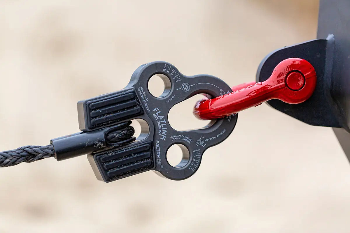 Black Factor 55 Flatlink Multimount connected to a winch line and red shackle, showcasing secure recovery setup for off-road use.