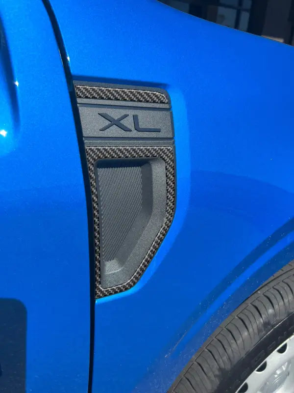 Blue car fender with XL trim and fender emblem overlays for Ford Maverick 2022-2024