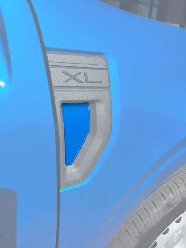 Blue car fender with XL badge in fender emblem pocket for Ford Maverick 2022-2024