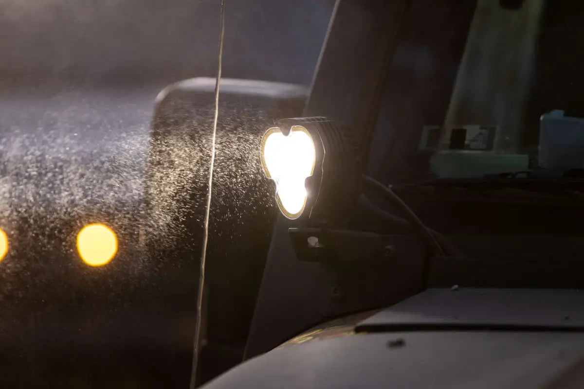 FLEX ERA® 3 LED light pod in action, illuminating through mist and mounted on an off-road vehicle for optimal visibility.