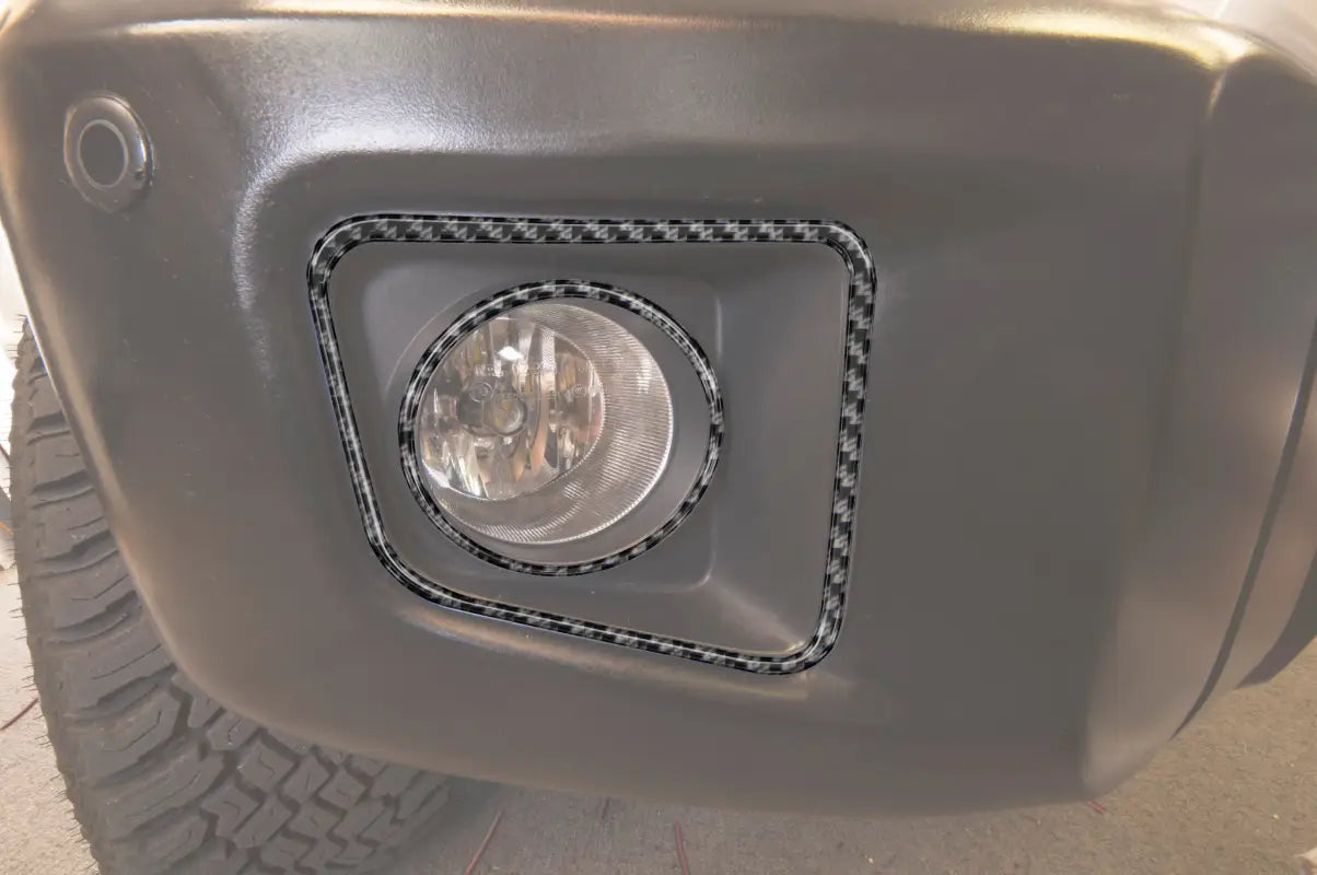 Carbon fiber-style fog light accent trim installed on a 2014-2021 Toyota Tundra bumper, enhancing the vehicle's appearance.